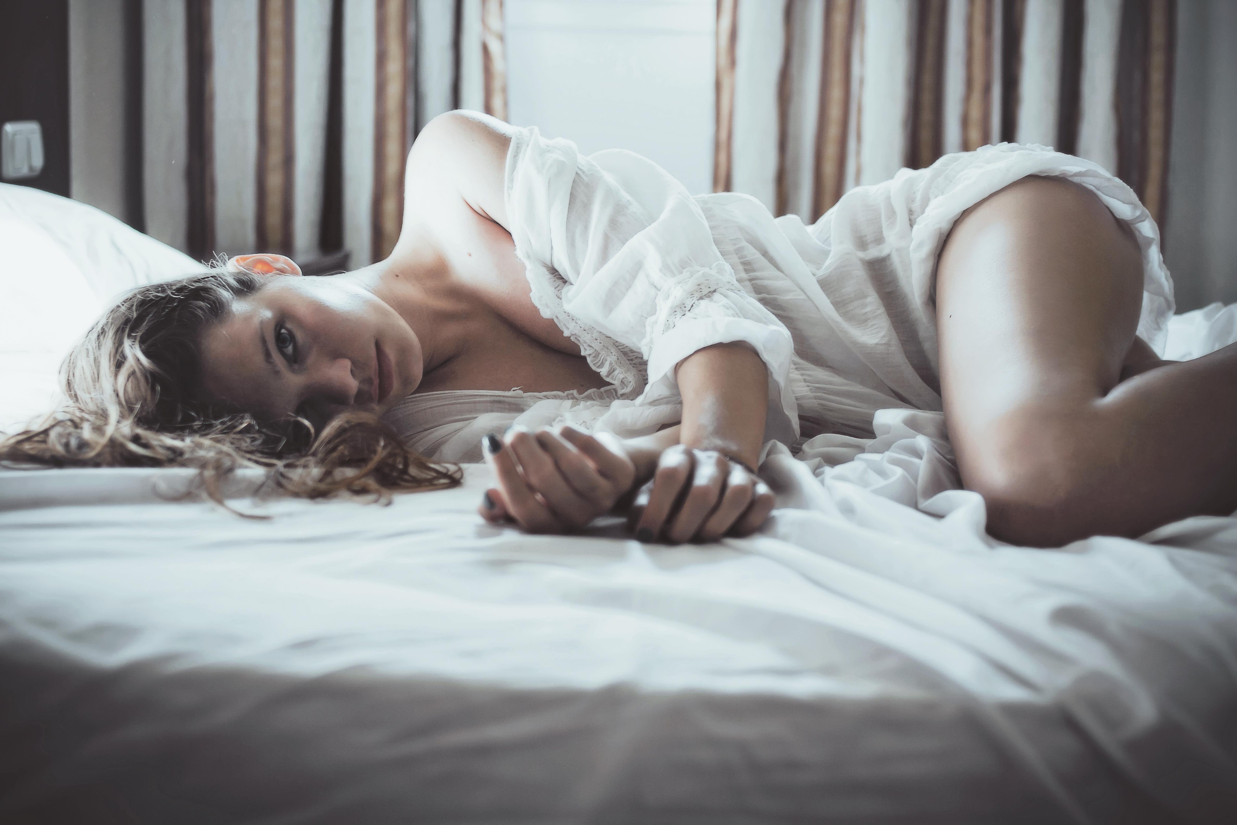 Фото одинокой блондинки показывающей сиськи в постели