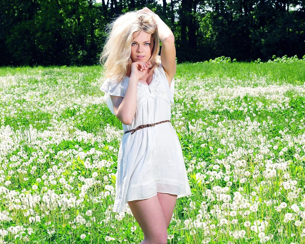 Подняв платье блондинка идёт по поляне фото