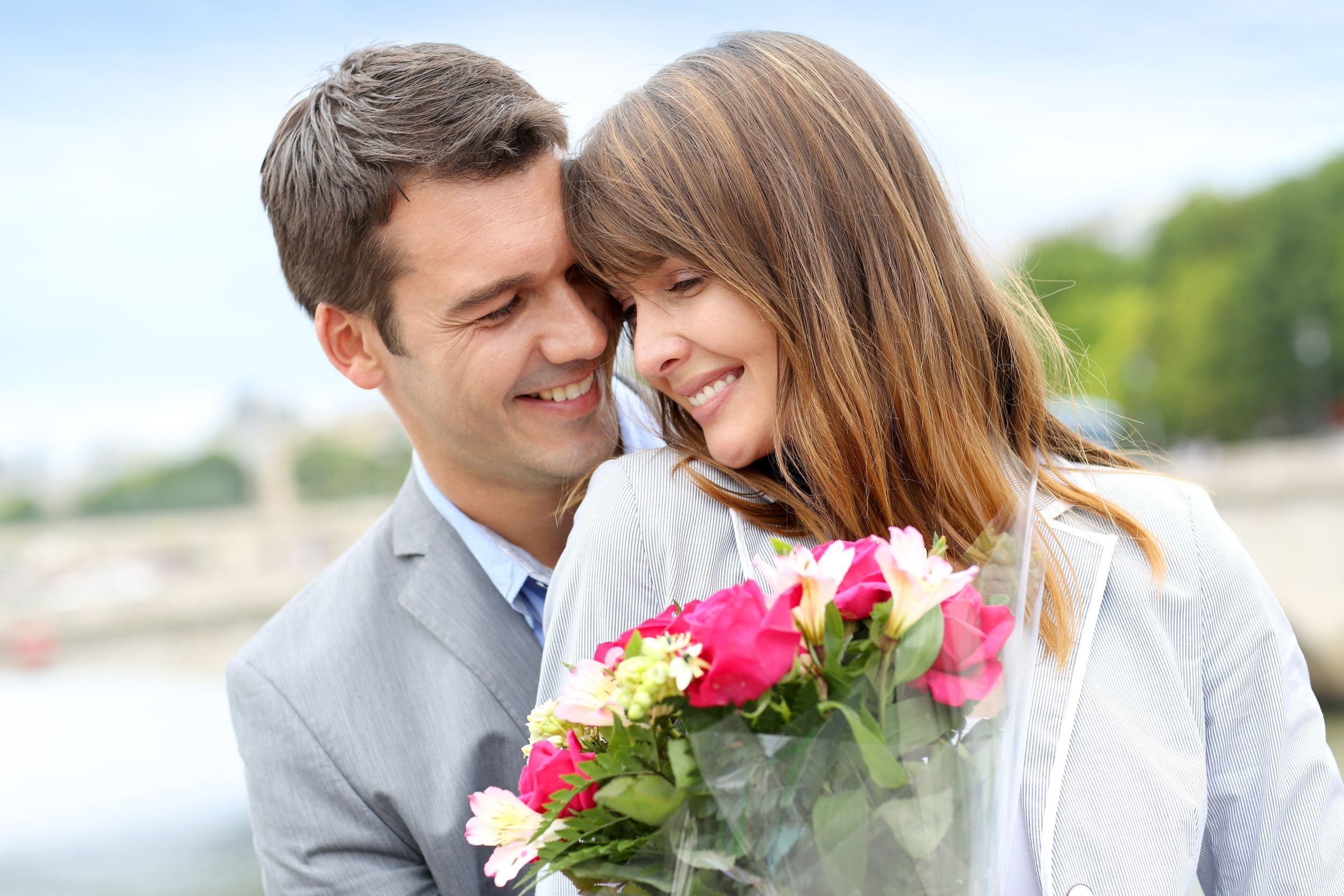 Молодая супруга дает молодому супругу. Мужчина дарит цветы женщине. Парень дарит девушке цветы. Девушке дарят цветы. Мужчина дарит букет цветов.